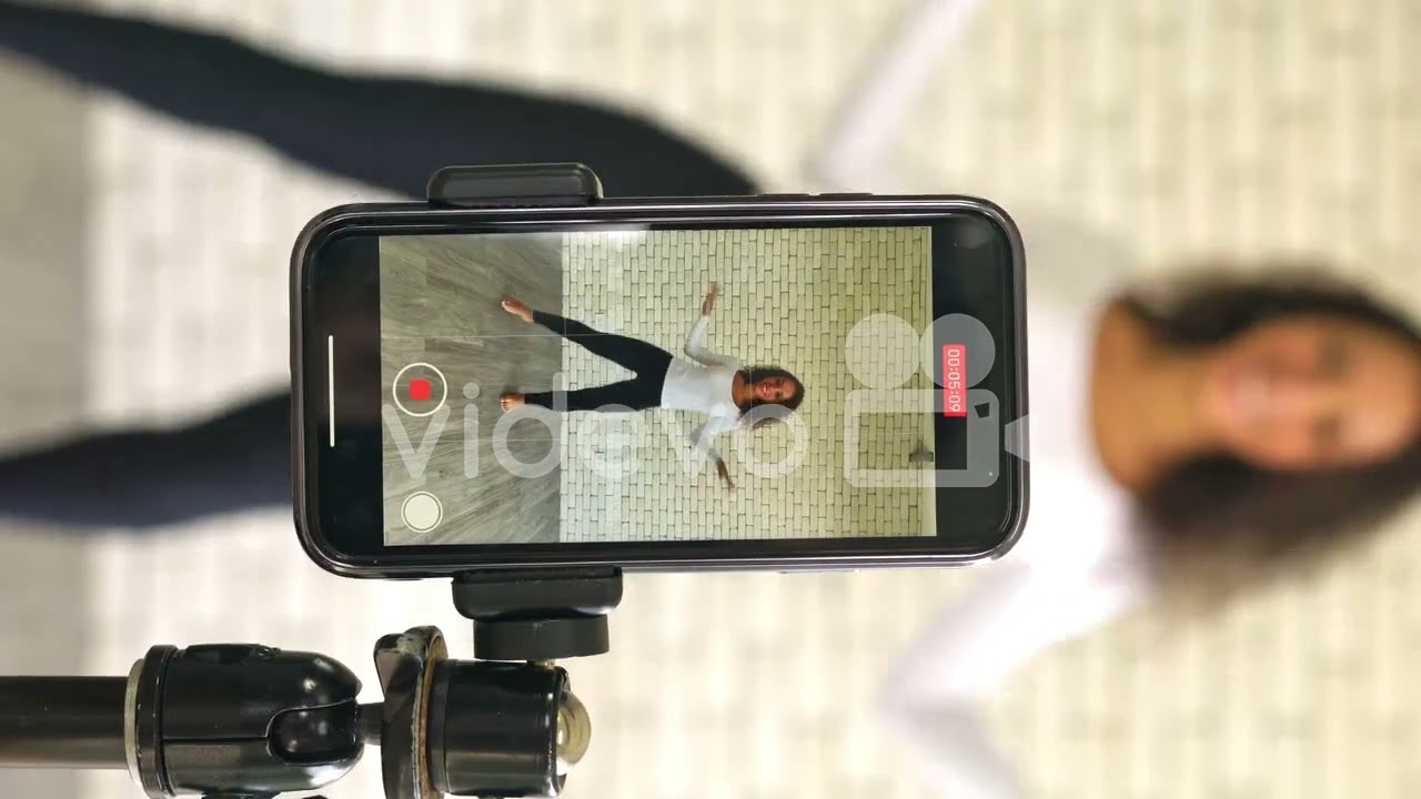 Latin woman influencer created her dancing video by smartphone camera