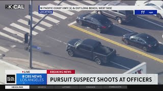 Suspect fires shots at pursuing officers out back of stolen vehicle