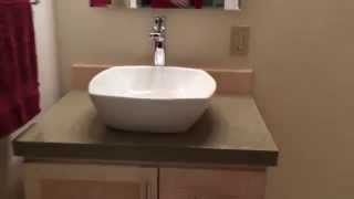 I redid my downstairs bathroom. I made a custom hard maple cabinet, topped with a concrete countertop slab that I made. I did all 