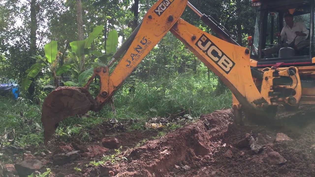 jcb 3dx moving rock pieces from road