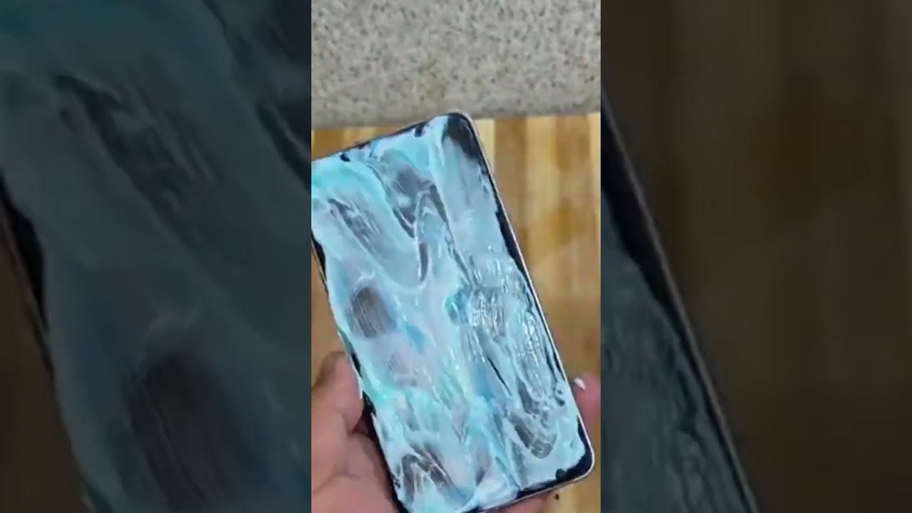 the process of cleaning splashes of broken glass on a cellphone screen using toothpaste