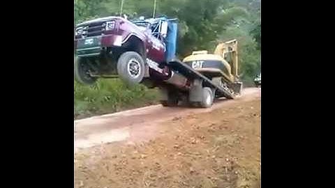 Loading excavator onto truck without ramps