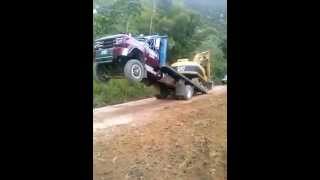 Loading excavator onto truck without ramps