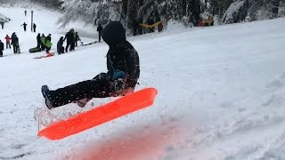 Kids catching air sledding on Mt. Tabor hill