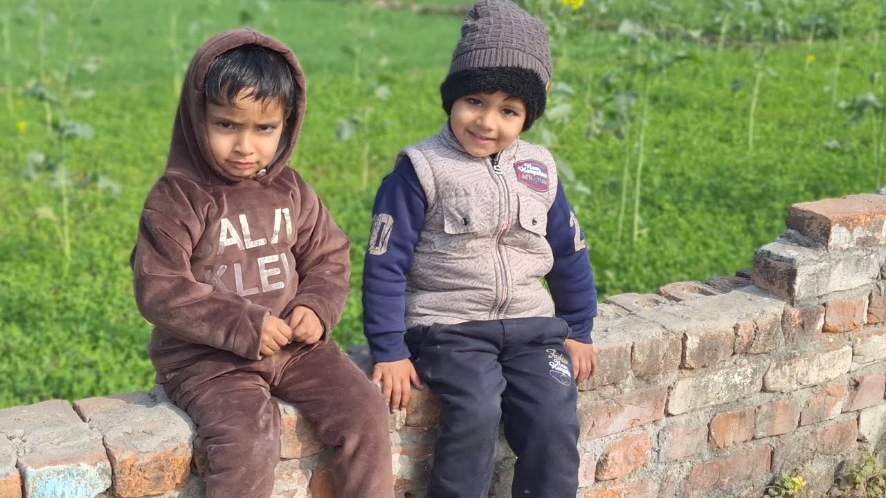 Two baby play in garden 