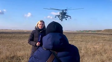 Dangerous Mi-24 Hind Attack helicopter passes over the reporter