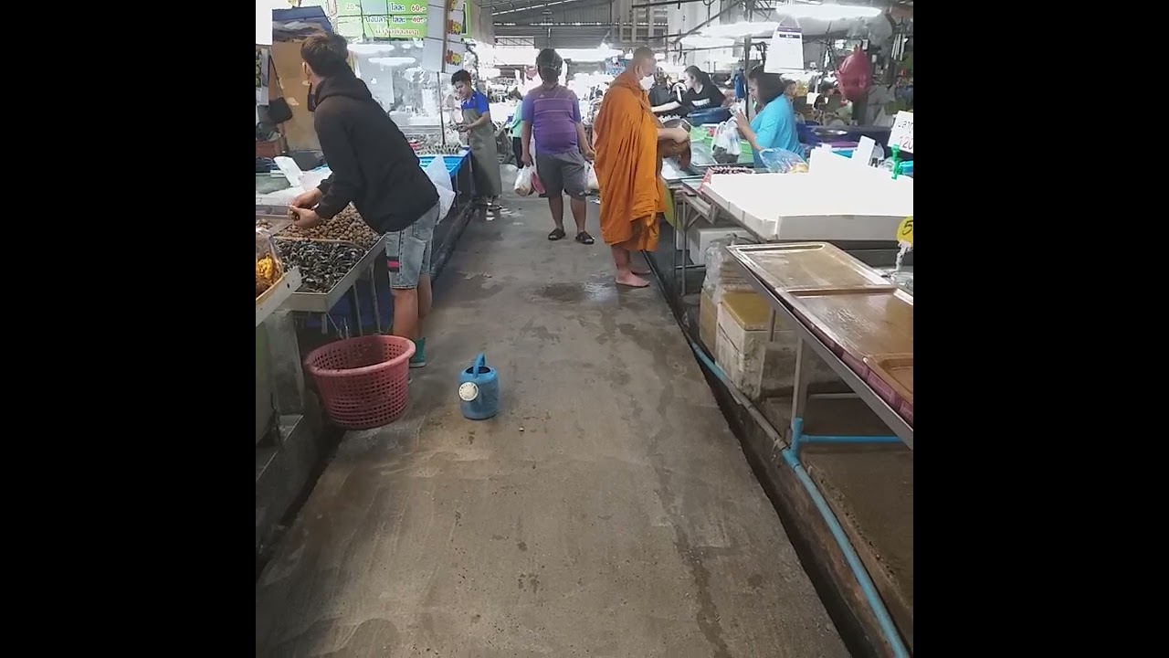 Thailand Buddhist Monk receive alms food in Ang Sila Fish Market 