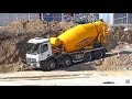 Man and Mercedes concrete trucks work with concrete pump