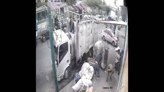 Worker Accidentally Drops Cardboard on Colleague