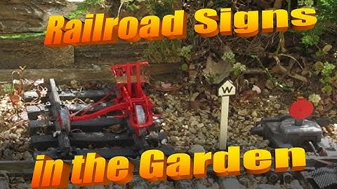 Multipurpose garden railroad signs, repurposing Lionel signs for G scale. Switch track clearing tool