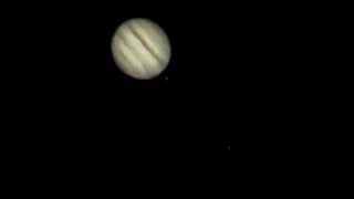 Jupiter rotating and occulting its moon Io