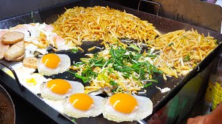 Amazing evening street food, eating street food fried short noodles with fried egg and beef