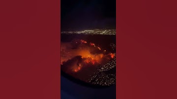 Video from the window of a plane shows the fires burning in Los Angeles