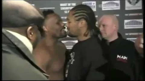 Derek Chisora kisses Carl Baker during a staredown