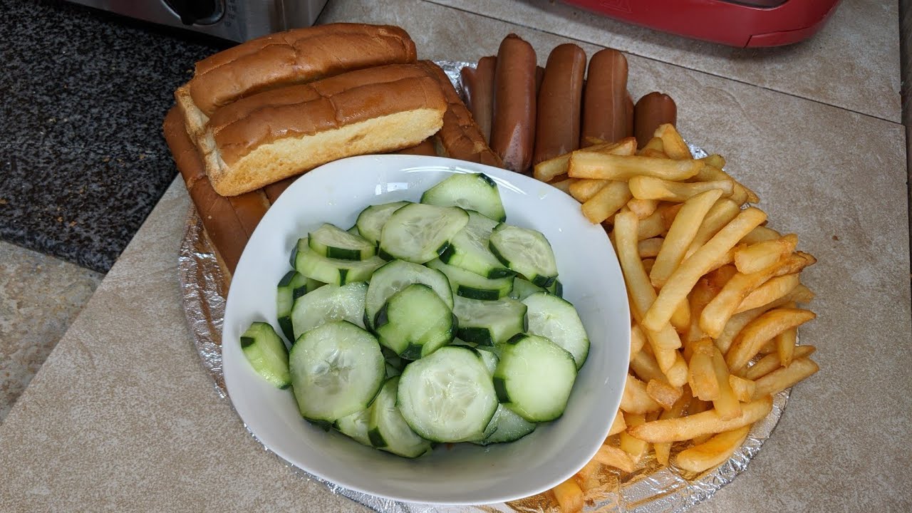 Toasted Hot Dogs & French Fries With A Side Of Cucumbers Living On