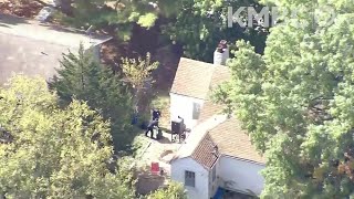 News Chopper 9 video of Excelsior Springs scene shows police digging through trash at house