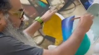 Artist Om Swami blending paint on his Ganesha sculpture