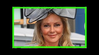 Carol vorderman, 56, struggles to contain huge boobs as they burst free