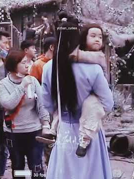 Wei Ying playing with little Ayuan whom Lan Zhan is carrying 🥰