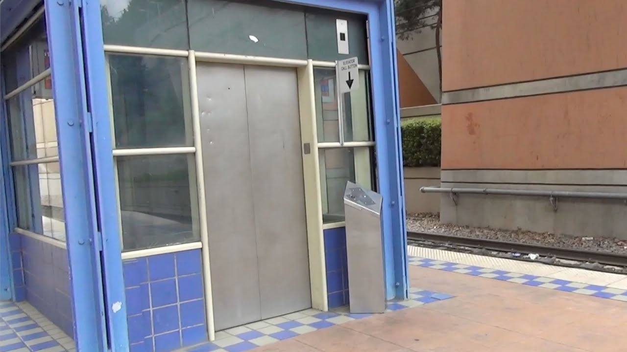 Dallas, TX: Tall Hydraulic Elevator at Mockingbird DART Station with view of train