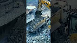 Excavator Caterpillar 385C  Loading Caterpillar 775E Dumper And Mercedes - MAN Truck