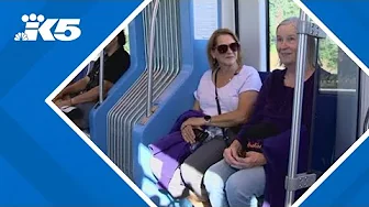 UW football fans pack trains, taking advantage of extension to Lynnwood thumbnail
