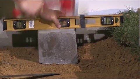 Installing a Concrete Block Retaining Wall Base Course with Base Block