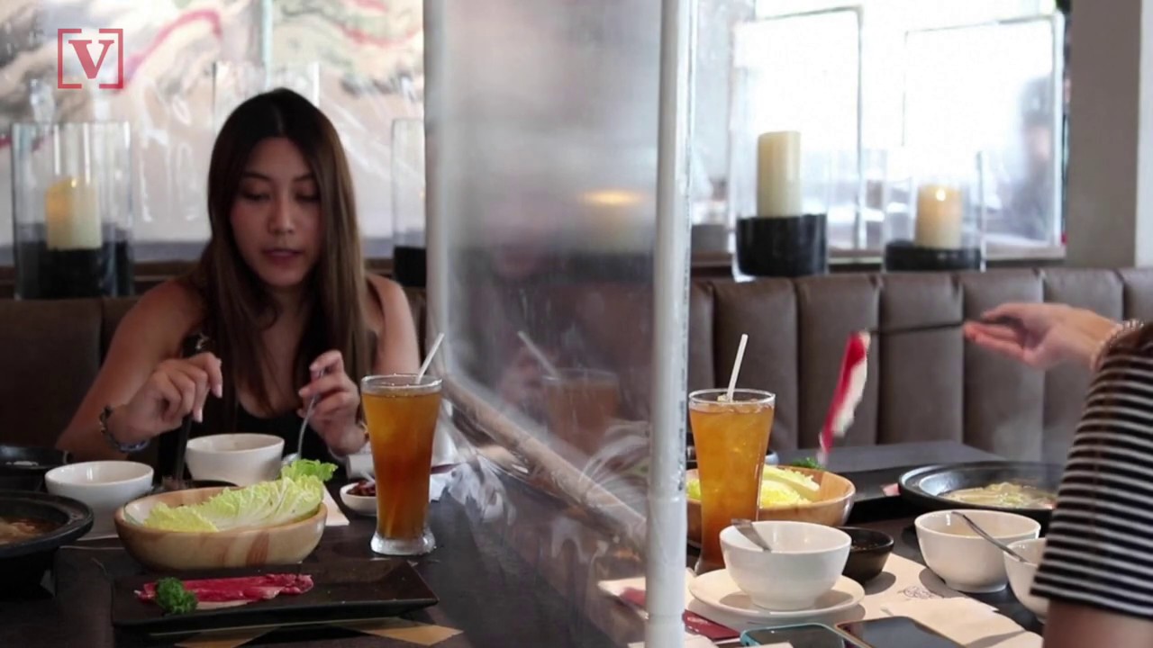 Plastic Dividers at Thai Restaurant Are One Social Distancing Measure After Pandemic Restrictions