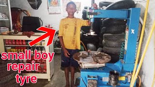 Small Boy repair Tyre In Tyre Changer Machine Manatec Tyre Changer