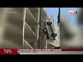 SUV dangles from downtown Austin parking garage after driver drives off the top floor SUV dangles from downtown Austin parking garage after driver drives off the top floor