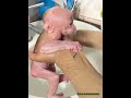 Dad gently takes care of the baby monkey while bathing it