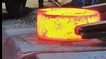 Forging high-temperature rectangular iron blocks into circular iron cakes before drilling