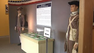 Explore Revolutionary War exhibit featuring historic paintings and global impact at museum expo