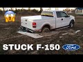 F-150 stuck in mud, saved by cat 259D skid steer