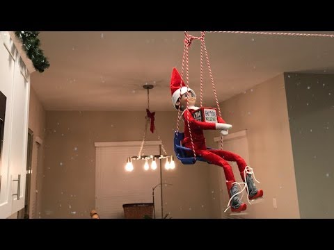 elf-on-the-shelf-caught-moving-and-talking,-swinging-on-a-zip-line!