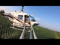 What it looks like crop dusting with a helicopter  - spray boom perspective