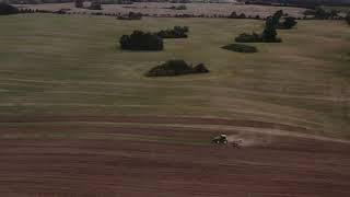 High Angle Drone Shot of Tractor Ploughing Agricultural Field | Free Stock Video