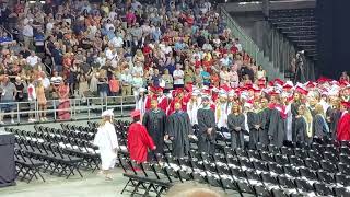 Kaylee walking in to DHHS Graduation Ceremony on 6/2/23 @ 7pm