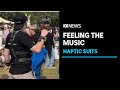 Hearing-impaired Australians feel the music with special suits at Deaf Festival | ABC News