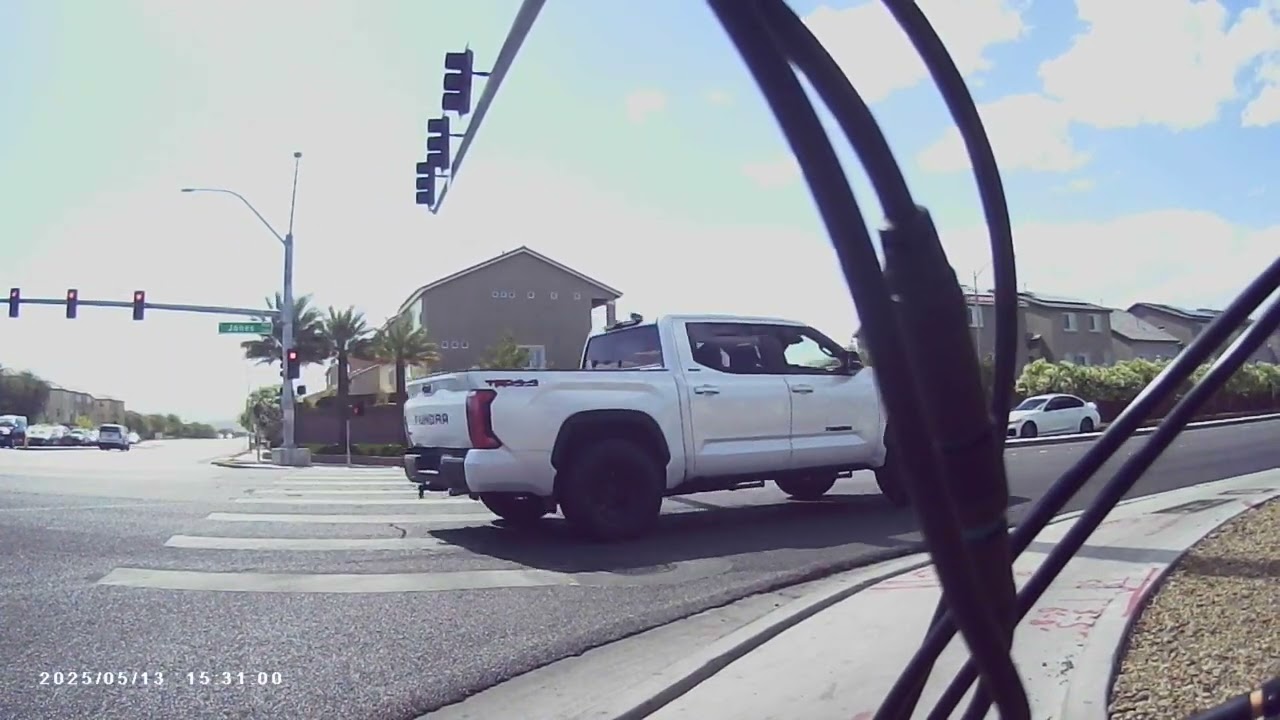 Woman holding slushie drink almost run over truck screeching tires crosswalk Warm Springs and Jones