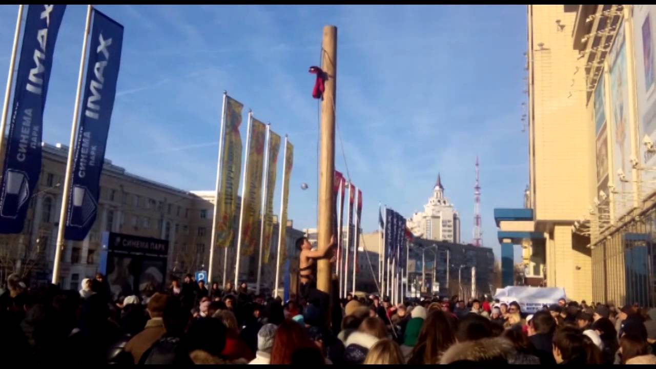 Russians adore to climb the post....    .... for Red Boots for their women on Maslenitsa Day