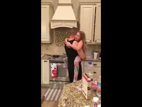 Dad Dances with Daughter in Kitchen