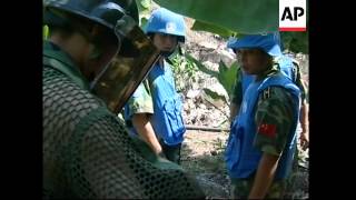 Chinese, French troops begin clearing cluster bombs from site