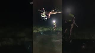 Guy hangs from tree branch flips forward and lands awkwardly