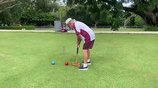 John demonstrating a stop shot in croquet