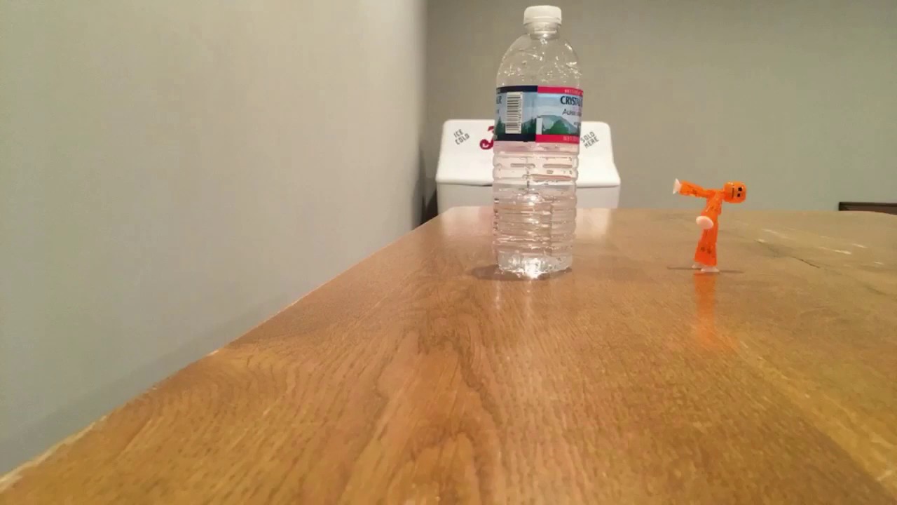 Stikbot attempts water bottle flip with force