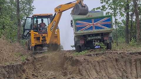 Jcb backhoe machine loading soil in heavy truck