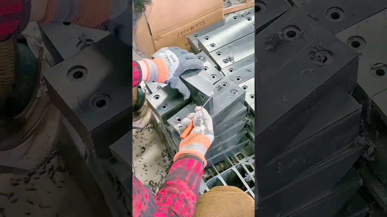 Skilled Worker Inspecting Precision Machined Steel Blocks in a High Volume Manufacturing Line