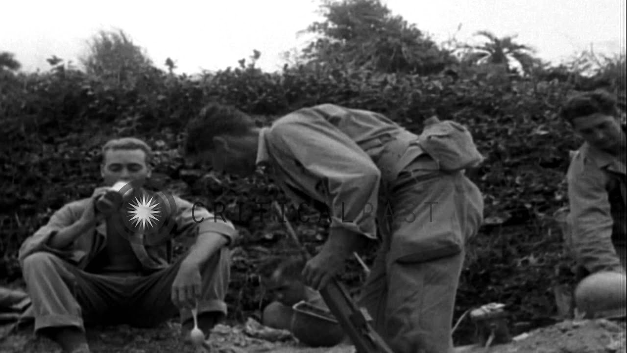 Soldiers of 305th Infantry of the 77th Division stop for a rest and smoke during ...HD Stock Footage
