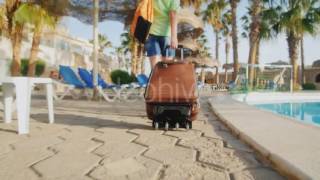 Steadicam Hot Woman With Travel Bag On Wheels Is On The Recreation Area | VideoHive 15389921